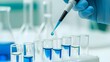 © Micro Stocks - Hand in blue glove using a pipette to dispense blue liquid into test tubes in a laboratory — symbolic representation of scientific research, medical testing, or pharmaceutical development