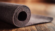 © hkjdesign - Rolled yoga mat on wood floor