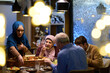 © .shock - Muslim family breaks their fast together in a decorated restaurant during Ramadan