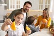 © New Africa - Happy family cooking together at table in kitchen, selective focus