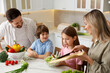 © New Africa - Happy family cooking together at table in kitchen