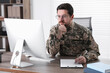 © New Africa - Military education. Student in soldier uniform learning at wooden desk indoors