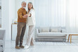 © New Africa - Lovely senior couple dancing together at home. Space for text