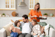 © New Africa - Happy family spending time together on sofa in kitchen at home