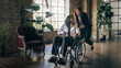 © Lomb - Inclusive workplace moment with colleague pushing a coworker in a wheelchair, diversity and friendship at work