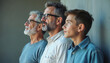 © Pete - Three Caucasian males aged boy father grandfather stand in row looking into distance showing unity and family support. Generations connect symbolizing hope and future.