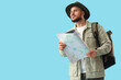 © Pixel-Shot - Male traveler with map on blue background. Search concept