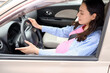 © Pixel-Shot - Young pregnant woman driving modern car