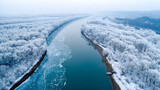 Aerial winter landscape of the songhua river with partially animated movie blue water and snow-covered trees along the banks