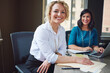 © ReeseFullyOwned/peopleimages.com - Women, team and smile with documents at office, review and meeting for project at insurance company. People, happy and solution with strategy, paperwork or feedback for risk management job at agency