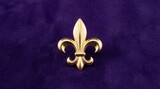 Golden fleur de lis symbol on a rich purple velvet background for design element or decorative motif for French culture, royalty.