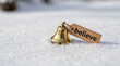© anthepixelproject - Golden bell with believe tag on snowy surface