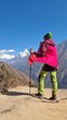 © MdAbu - Vibrant jacket-clad hiker embraces breathtaking mountain vista, a testament to adventure and the call of the wild