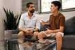 © kleberpicui - Father listening attentively to his teenage son during a calm conversation at home. Concept of active listening, emotional intelligence and family communication