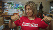 © Krakenimages.com - Woman flexes tensed arm muscles in bright home decor shop interior; empowerment confidence determination.