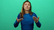 © Krakenimages.com - Woman expressing various emotions against isolated green background wearing blue sweater showing range of gestures suggesting conversation or discussion