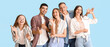© Pixel-Shot - Group of happy friends gesturing on blue background