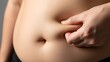 © Hani Nuang - abdominal belly fat pinch, overweight and body fat concept.