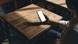 © Shibu - Person holding a smartphone on a wooden table in a dark room