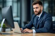© HENDRANTO - Confident Male Professional Working on Laptop in Modern Office