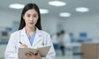 © YiuCheung - Young female doctor in white coat, stethoscope, holding clipboard in modern clinic.