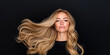 © sam richter - Golden locks sweep dramatically sideways creating dynamic stylish look against dark backdrop.