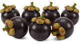 A Luscious Cluster of Six Whole Mangosteens with Glossy Purple Rinds Isolated on a White Background.