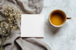 © lnsdes - cup of tea beside a blank card and dried flowers on a gray cloth