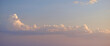 © Pihuliak - Soft pastel sky with fluffy cumulus clouds illuminated by warm evening light, calm atmospheric landscape, minimal background, peaceful mood, natural weather scene