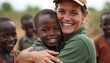 © Pete - Woman hugs young African child warmly outdoors. Smiling volunteer offers help and support to needy kids. Love, care and compassion shown in community.