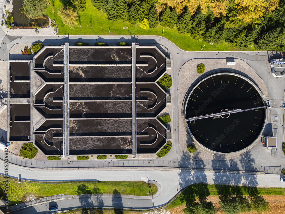 A wastewater treatment plant in a developed area promotes water management and community services for environmental and economic growth.