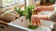 © AcikLens - Person washing fresh carrots in a kitchen sink with running water