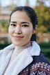 © SHOTPRIME STUDIO - Smiling woman in an outdoor setting wearing a shearling jacket with a patterned trim, casual fashion style and warm outerwear suitable for autumn days and cool weather