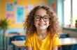 © Viktor - Young girl with curly hair wears glasses in a vibrant classroom. She smiles cheerfully, engaged in her studies. This portrait shows optimism and learning joy.