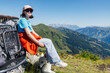 © Elena Medoks - Young hiker resting with her dog enjoying a breathtaking mountain view