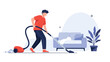 © Washim - A young man doing household chores, using a red vacuum cleaner to clean the carpet in a modern living room setting.