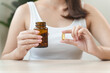 © Pormezz - person prepare fish oil pills to her hands taking daily supplement