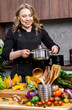 © 5ph - Chef holding stainless steel pot with steaming food in bright home kitchen, preparing fresh vegetables for healthy meals and culinary lifestyle visuals. Healthy eating, cooking blog, kitchen lifestyle