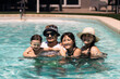 © ADDICTIVE STOCK - Happy family enjoying a summer day at the pool