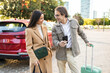 © ADDICTIVE STOCK - Couple getting ready for a trip with car and luggage