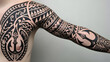 © MuhammadRizki - Close-up shot of a person's arm and torso showcasing an intricate black tattoo with various patterns and designs on a plain gray background, highlighting people style.
