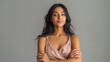 © nhannan - Ai woman posing in pagamas with arms crossed against plain backdrop in indoor setting during day