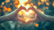 © Agung - Hands Making Heart Shape Against Golden Sunset Bokeh