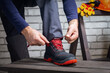 © Sergey - Close-up of worker putting on shoes for work. Safety work.