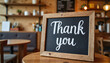 © Olga's Design - Chalkboard with thank you message, warm atmosphere, in cozy café environment