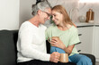 © brizmaker - Elderly mother and adult daughter share a joyful moment at home together