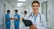 © NN AI - Smiling female doctor with stethoscope in hospital corridor. Vertical portrait of professional healthcare practitioner looking at camera