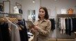 © NN AI - Female small business owner using tablet for inventory management in clothing store. Young entrepreneur working in her modern fashion boutique