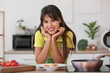 © Pixel-Shot - Young housewife with tasty pasta at table in kitchen