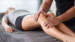 © vasyl pshyk - Massage therapy session with a focus on knee and leg muscle relaxation at a wellness center in the afternoon